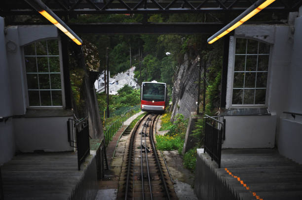 A red funicular going up floyen in bergen Floyen funicular goin to the top of a montain Located in Scandinavia, Norway in Bergen city fløyen stock pictures, royalty-free photos & images