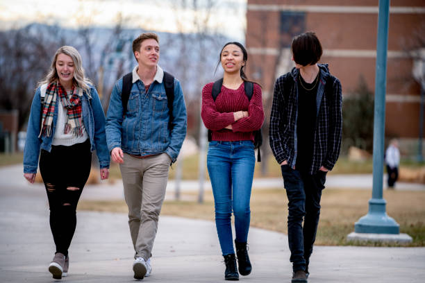istock A Diverse Group Of College Students Talking As They Walk To Class 1213595745