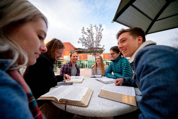 um grupo de estudantes que têm uma discussão e estudam a bíblia - study bible group of people talking - fotografias e filmes do acervo