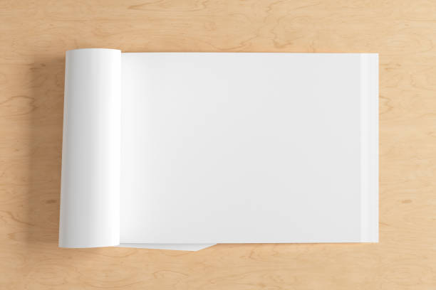 istock Blank magazine page. Workspace with folded magazine mock up on the desk. 1213598324