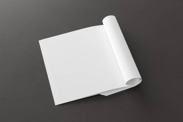 istock Blank magazine page. Workspace with folded magazine mock up on the desk. 1213598331