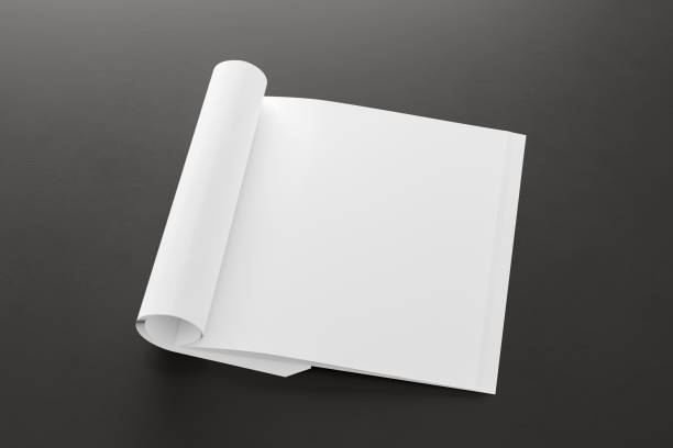 istock Blank magazine page. Workspace with folded magazine mock up on the desk. 1213598345