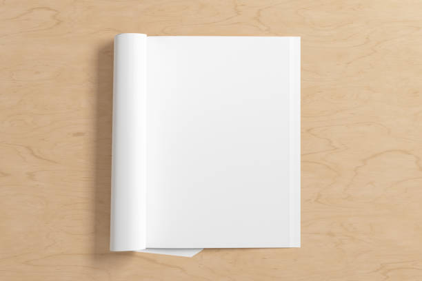 istock Blank magazine page. Workspace with folded magazine mock up on the desk. 1213598377