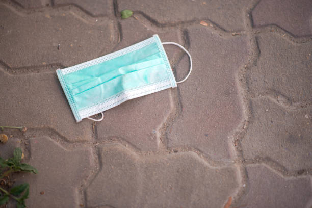 istock Someone just throws a used mask on the street 1213606257