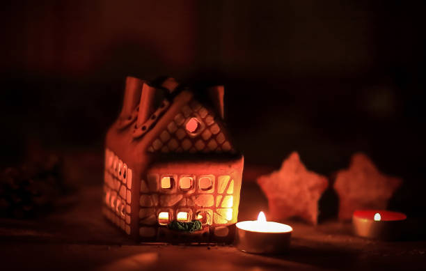 istock gingerbread house candle on blurred background of the table. 1213606362