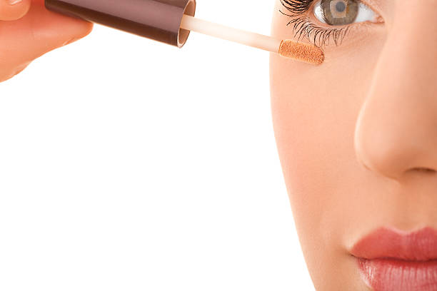 istock Close-up of a female applying make-up 121360995