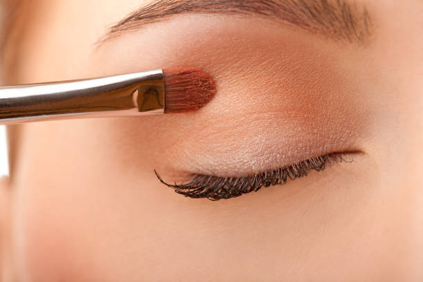 istock Close-up female applying make-up 121361063
