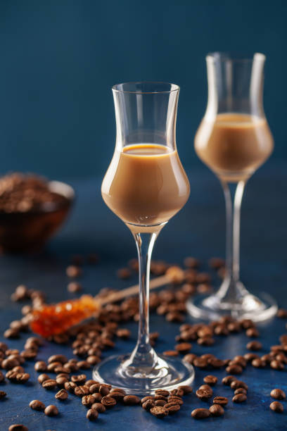 istock Irish cream or Coffee Liqueur and coffee beans on blue background 1213611588