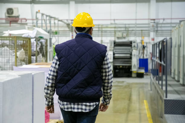 istock Back view of printing worker walking at factory 1213614249