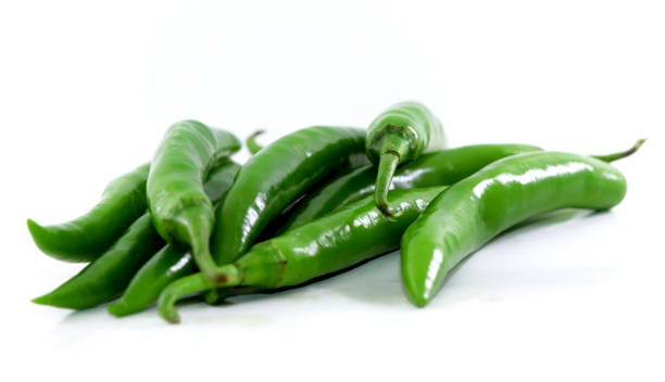 bunch of fresh green chili peppers on a white background bunch of fresh green chili peppers on a white background green chilli pepper stock pictures, royalty-free photos & images