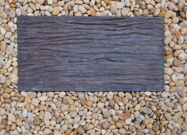 istock Piece of rectangle wood on pebble as background copy space 1213614895