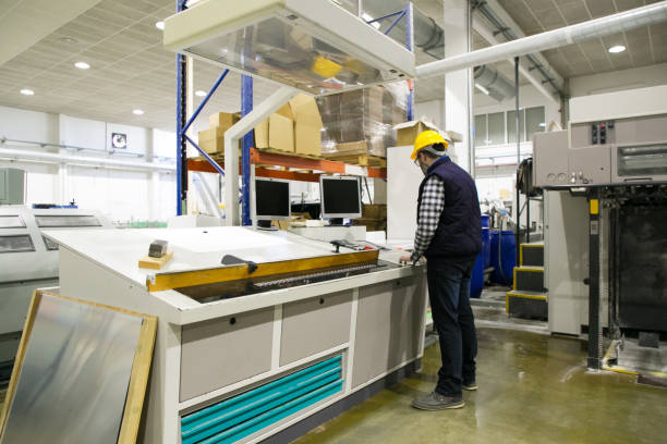 istock Back of male technician operating milling machine 1213617089