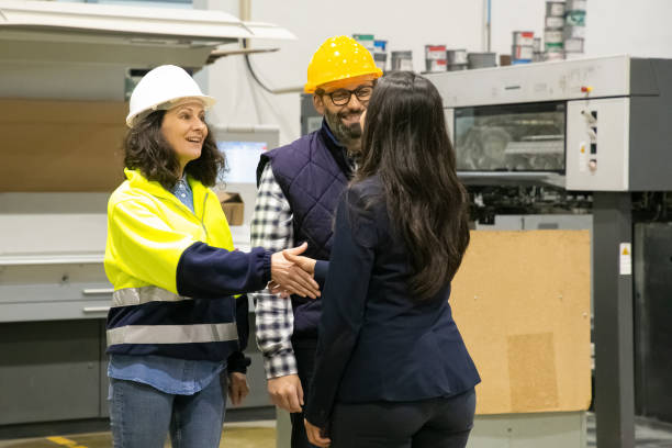 istock Smiling factory worker shaking hands with office manager 1213620379