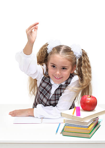istock Young girl at a desk, hand raised 121362180