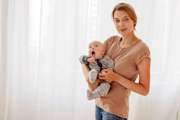 istock Beautiful female with cute baby 1213623516