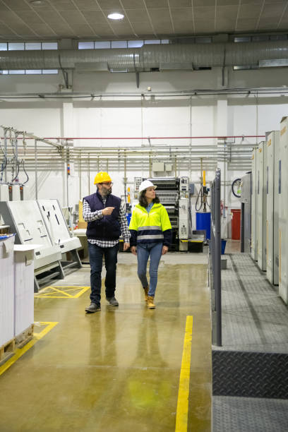 istock Two professional technicians inspecting printing factory 1213627067