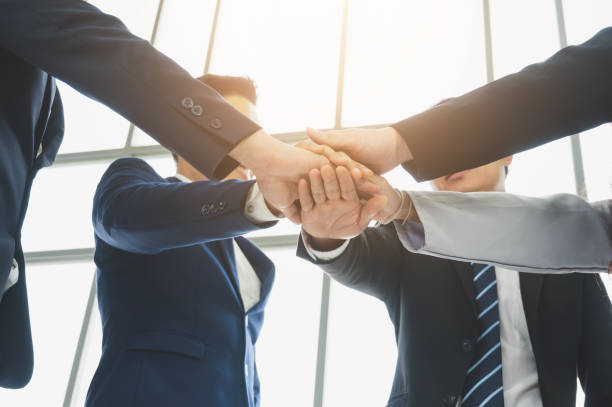 istock Asian business people putting their hands together. 1213628213
