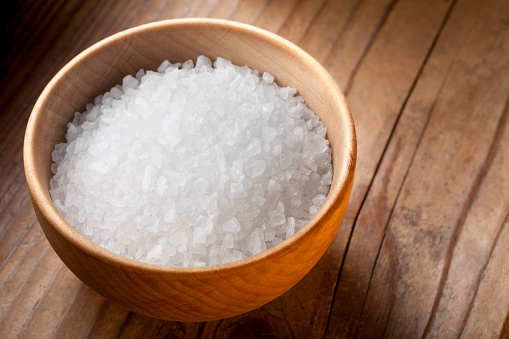 Salt in wooden bowl.