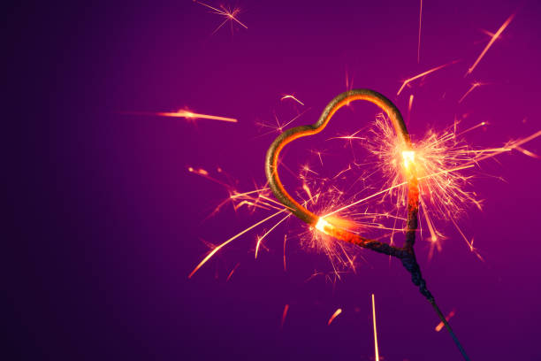 Golden heart shaped sparkler burning bright