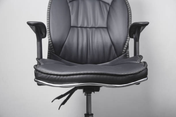 istock Black leather office chair in grey background. 1213631256