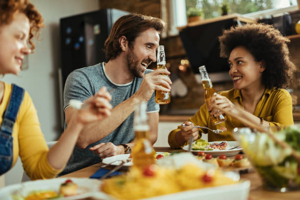 istock Happy couple toasting while eating lunch at dining table. 1213634445