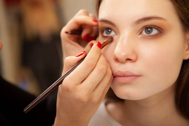 istock Beautiful woman getting professional makeup done 1213635974