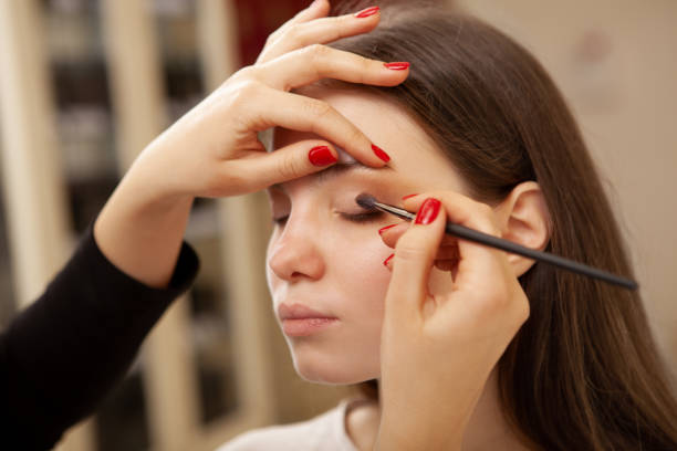 istock Beautiful woman getting professional makeup done 1213636020