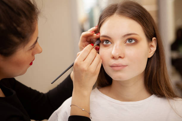 istock Beautiful woman getting professional makeup done 1213636036