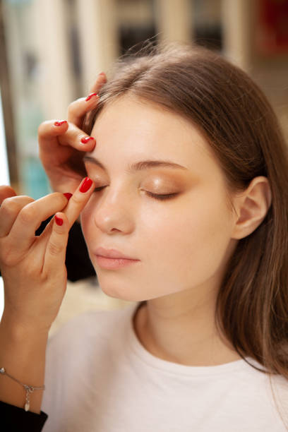 Beautiful woman getting professional makeup done