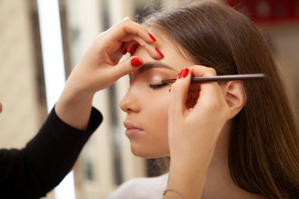 istock Beautiful woman getting professional makeup done 1213636294