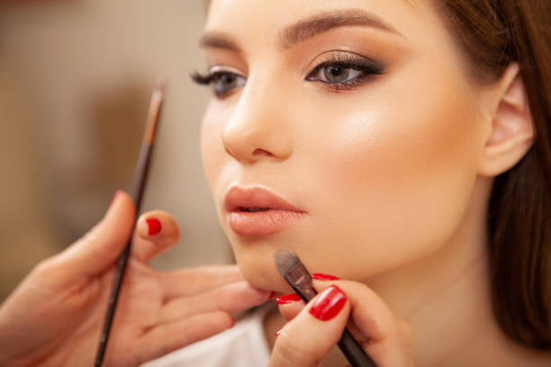istock Beautiful woman getting professional makeup done 1213636986