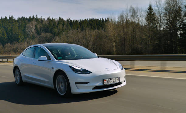 Tesla Model 3 Performance Minsk, Belarus - March 20, 2020: Tesla Model 3 Performance drives on a highway. It has dual motor all-wheel drive, total output is 451 hp. Model 3 is the world's best-selling plug-in electric vehicle. tesla model 3 stock pictures, royalty-free photos & images