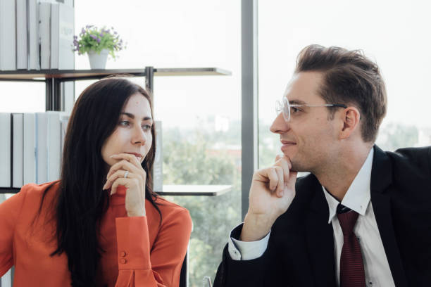 istock Two business people discussing about work in an office. 1213638280