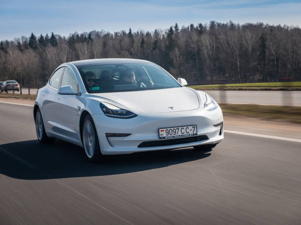 Tesla Model 3 Performance Minsk, Belarus - March 20, 2020: Tesla Model 3 Performance drives on a highway. It has dual motor all-wheel drive, total output is 451 hp. Model 3 is the world's best-selling plug-in electric vehicle. tesla model 3 stock pictures, royalty-free photos & images