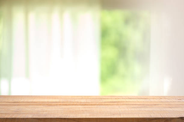 istock Empty wood table with blur curtain with window green garden from background. 1213639204