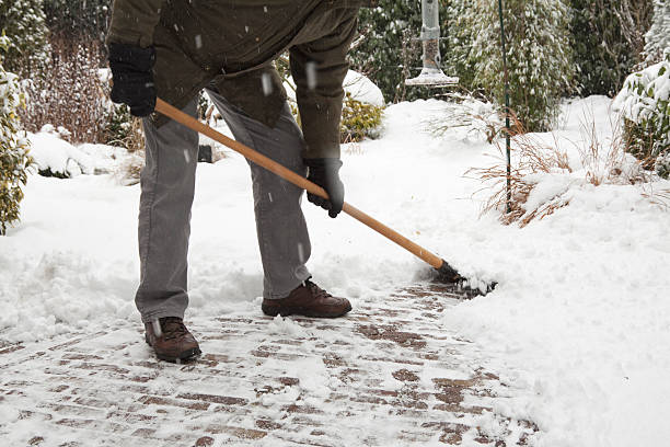 istock A man shoveling the snow on a foot path 121364210