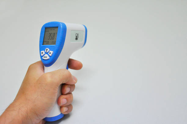 digital infrared thermometer for body temperature scan from coronavirus disease 2019 (covid-19). - termómetro digital imagens e fotografias de stock