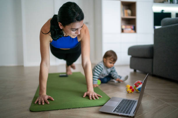 Mother Exercise With Her Baby At Home