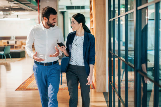 istock Cheerful business persons walking together 1213645431