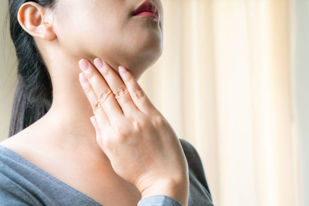 Sore Throat. Beautiful woman hand touching her pain neck. Woman healthcare concept Sore Throat. Beautiful woman hand touching her pain neck. Woman healthcare concept neck stock pictures, royalty-free photos & images