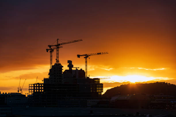 Construction projects using cranes Photo of cranes being used to work on a construction project during sunset in Gothenburg, Sweden. gothenburg by night sweden scandinavia stock pictures, royalty-free photos & images
