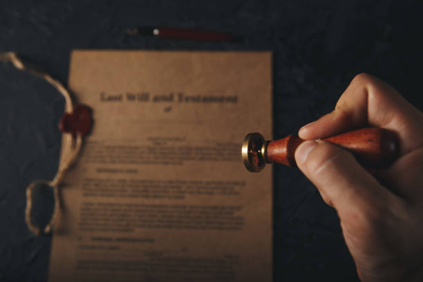 istock Notary's public pen and stamp on testament and last will. Notary public tools 1213647063