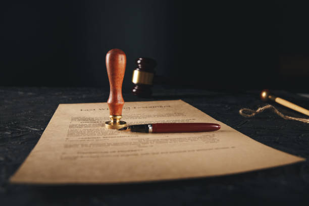 istock Notary's public pen and stamp on testament and last will. Notary public tools 1213648599