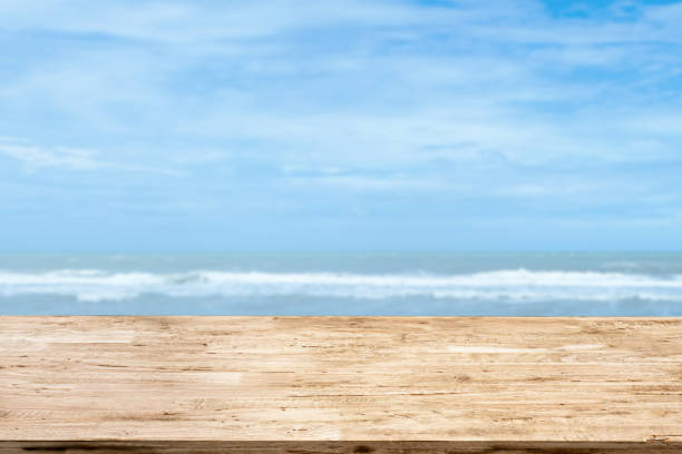 istock light brown wood table on blurred seascape background 1213648700