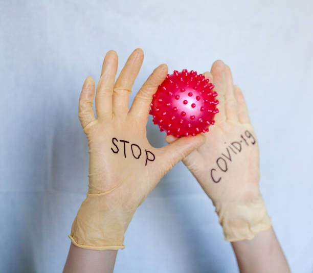 istock Stop Covid-19. Text on medical gloves. 1213651636