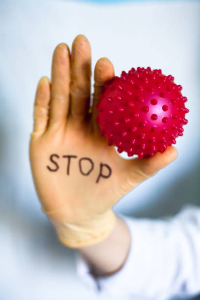 istock Stop Covid-19. Text on medical glove. 1213651638