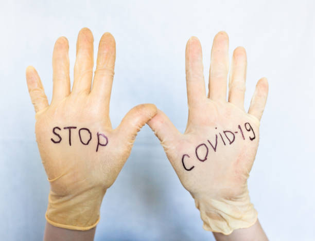 istock Stop Covid-19. Text on medical gloves. 1213651642