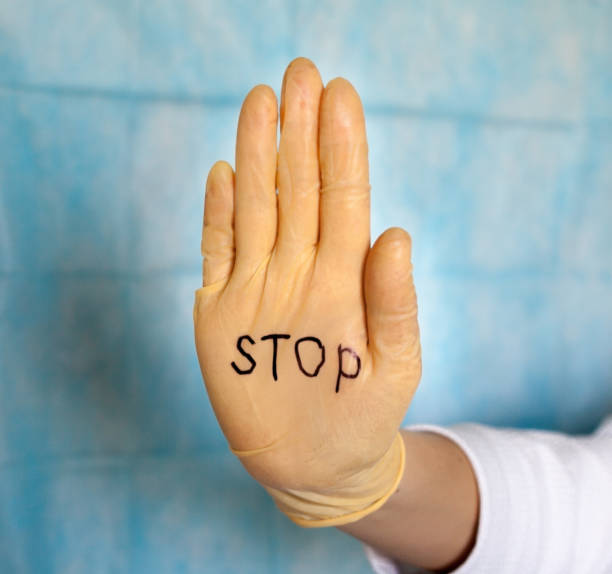 istock Stop. Text on a medical glove. 1213651645