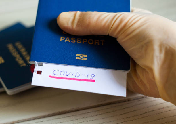 istock Passport and note with Covid-19 inscription. 1213651675