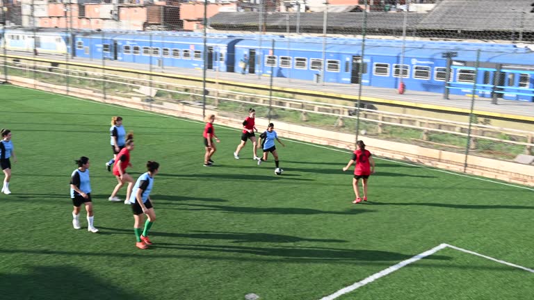 Female footballer dribbling and passing for goal kick